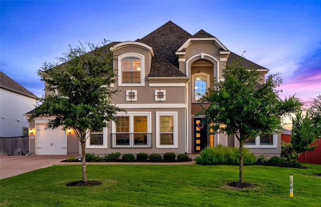 view of front of home featuring a lawn and a garage