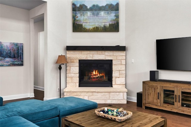 living room featuring dark hardwood / wood-style flooring and a fireplace