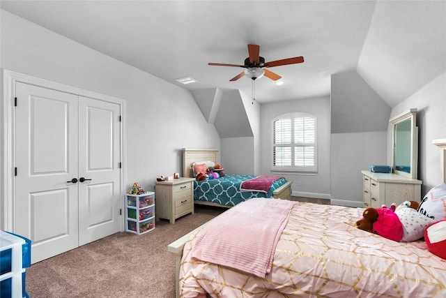 carpeted bedroom with ceiling fan, a closet, and lofted ceiling