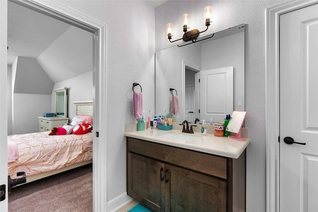 bathroom with vanity and lofted ceiling