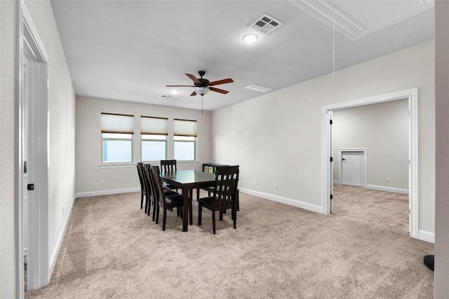 dining room with light carpet and ceiling fan