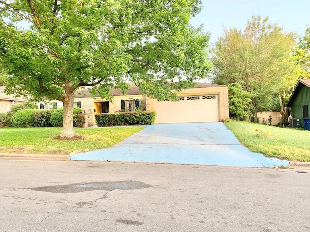 view of front of property with a garage and a front lawn