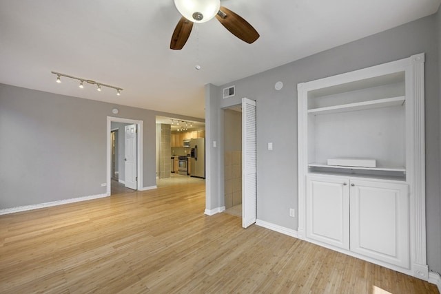 interior space with ceiling fan and light hardwood / wood-style floors