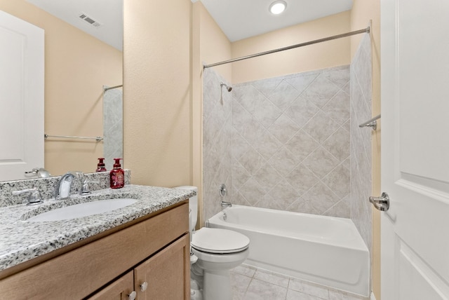 full bathroom featuring tile patterned floors, vanity, toilet, and tiled shower / bath combo