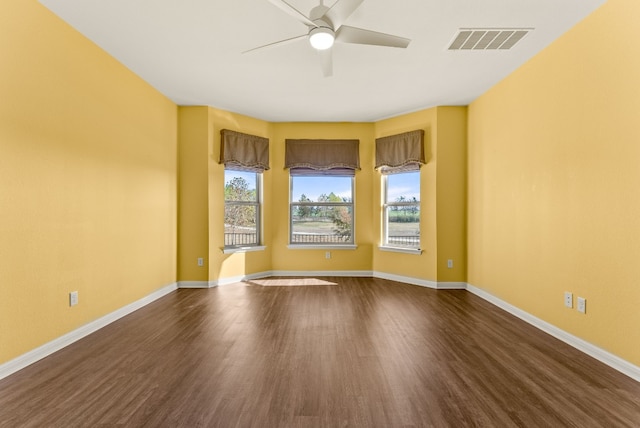 spare room featuring ceiling fan and dark hardwood / wood-style flooring