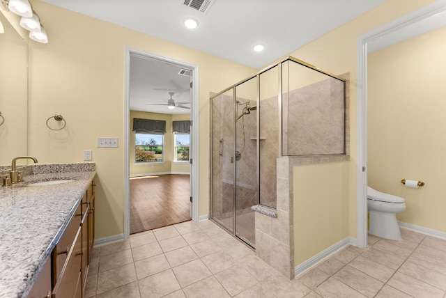 bathroom featuring vanity, tile patterned flooring, ceiling fan, toilet, and a shower with shower door