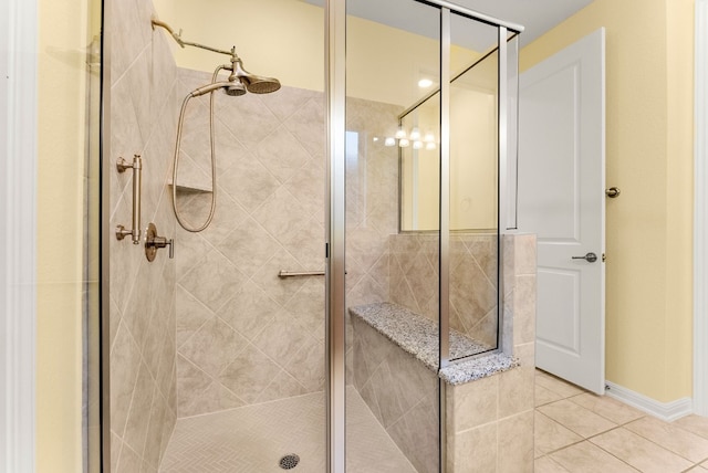 bathroom with tile patterned flooring and a shower with shower door