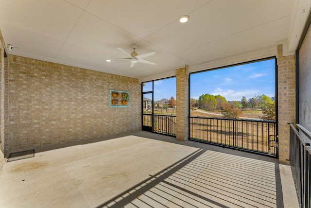 sunroom / solarium featuring ceiling fan