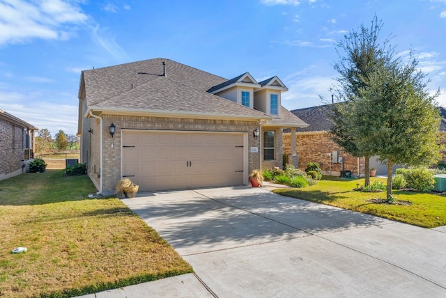 view of front of home with cooling unit, a garage, and a front lawn