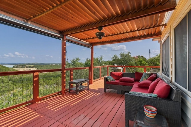 wooden terrace with ceiling fan and an outdoor hangout area