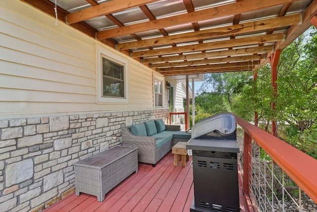 wooden terrace with an outdoor hangout area and area for grilling