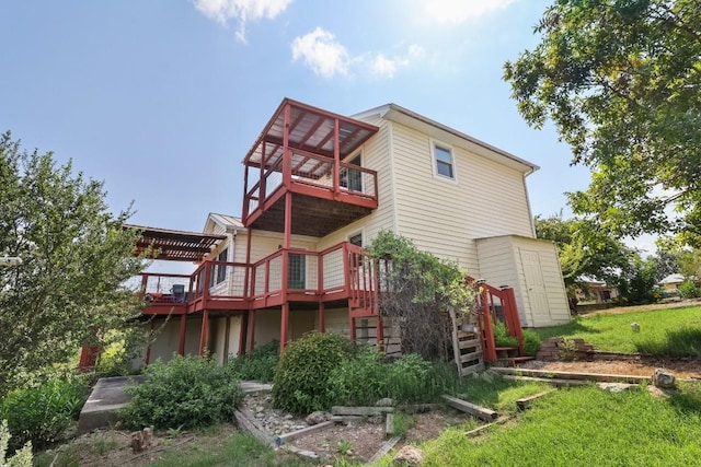 rear view of house featuring a deck and a balcony