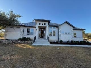 view of front of home with a garage and a front lawn