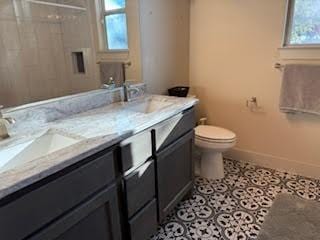 bathroom featuring tile patterned flooring, vanity, and toilet