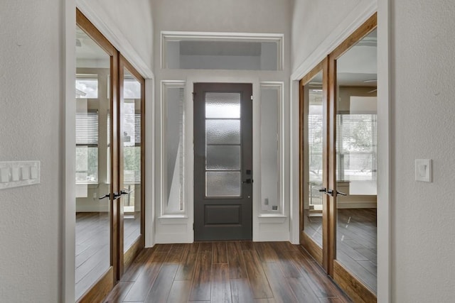 entrance foyer with dark hardwood / wood-style flooring and french doors