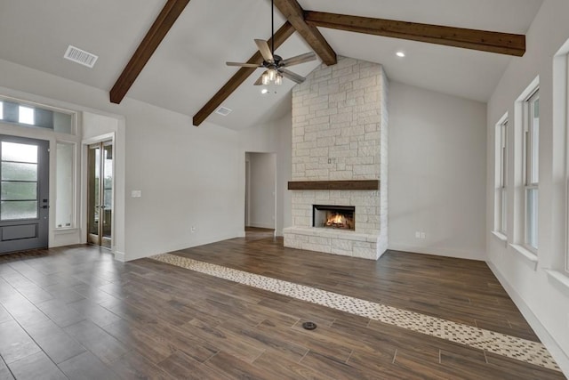 unfurnished living room with beamed ceiling, ceiling fan, a fireplace, and high vaulted ceiling