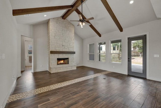 unfurnished living room with a fireplace, beam ceiling, high vaulted ceiling, and ceiling fan