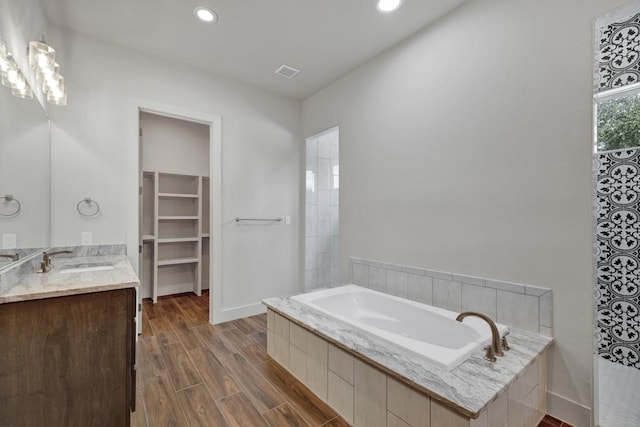 bathroom with a bath and vanity