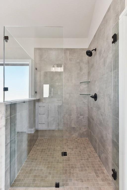 bathroom with a shower with shower door