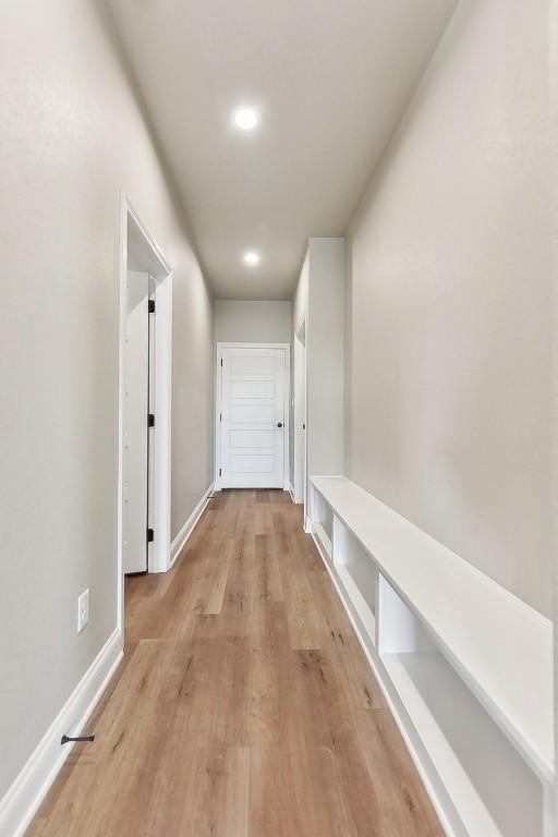 hallway with light hardwood / wood-style flooring