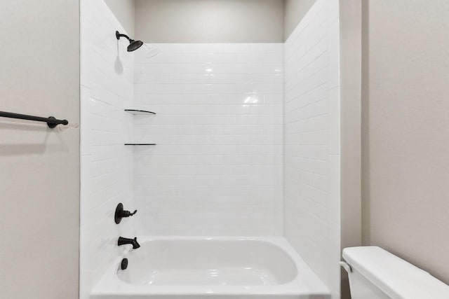 bathroom featuring shower / bath combination and toilet