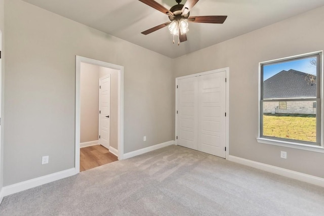 unfurnished bedroom featuring ceiling fan and light colored carpet