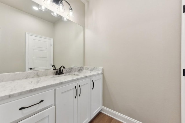 bathroom featuring hardwood / wood-style flooring and vanity