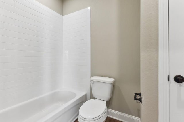 bathroom featuring shower / bathing tub combination, toilet, and wood-type flooring