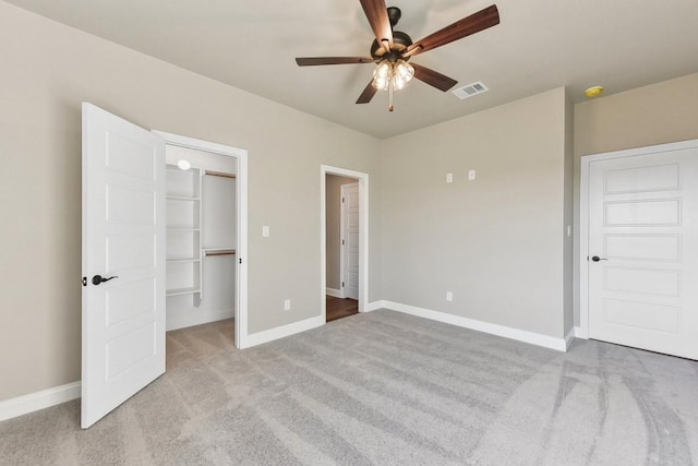 unfurnished bedroom featuring ceiling fan, a closet, and light carpet