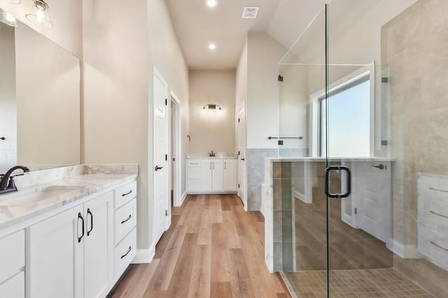 bathroom featuring hardwood / wood-style floors, vanity, and an enclosed shower