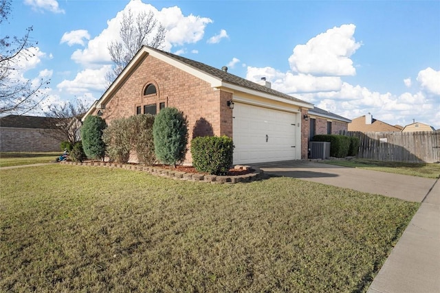 view of side of home featuring a lawn and a garage