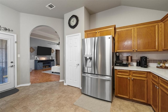 kitchen with decorative backsplash, stainless steel refrigerator with ice dispenser, and ceiling fan