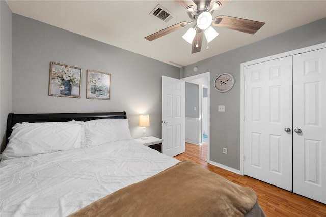 bedroom featuring light wood-type flooring, a closet, and ceiling fan