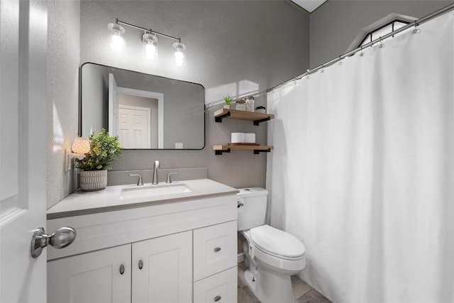 bathroom featuring tile patterned floors, vanity, and toilet