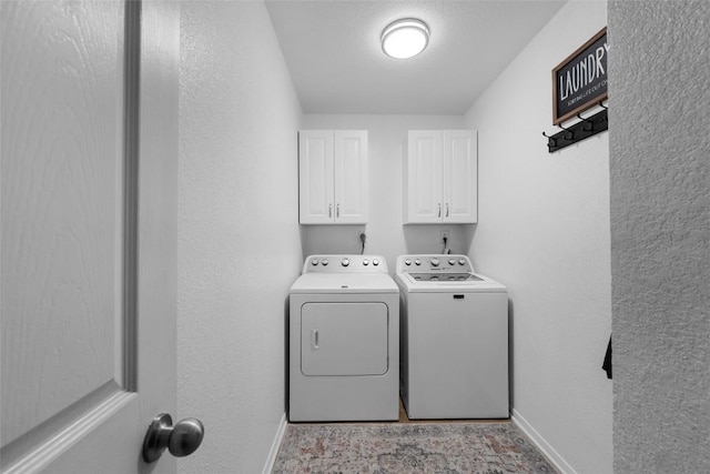 laundry room featuring cabinets and separate washer and dryer