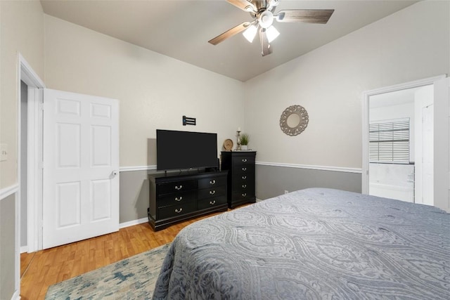 bedroom with ceiling fan, wood-type flooring, and lofted ceiling