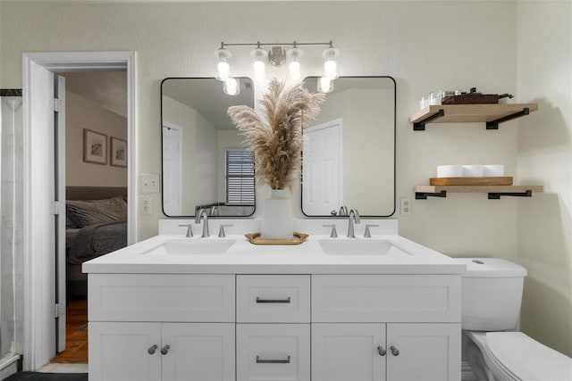 bathroom featuring vanity and toilet