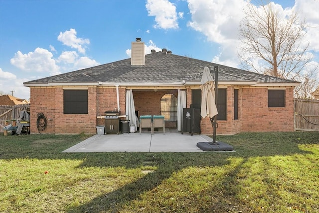 back of property with a patio area and a yard