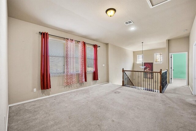 unfurnished room featuring light colored carpet