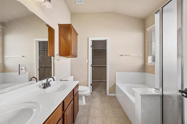 bathroom with vanity, tile patterned flooring, lofted ceiling, toilet, and a tub