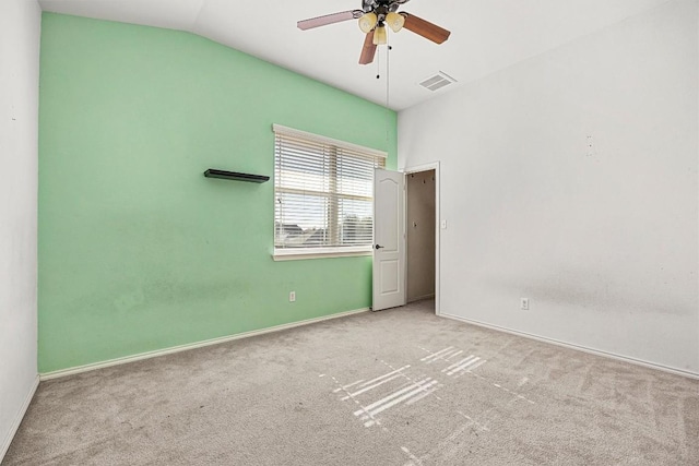 unfurnished room featuring ceiling fan, light carpet, and vaulted ceiling