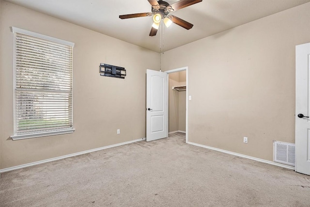 carpeted empty room with ceiling fan