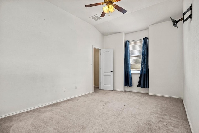 carpeted spare room featuring ceiling fan and vaulted ceiling