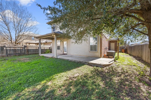 rear view of property with cooling unit, a yard, and a patio