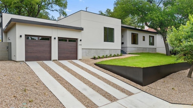 contemporary home with a front lawn and a garage