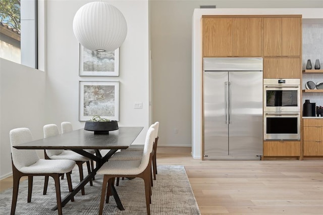 dining area with light wood-type flooring