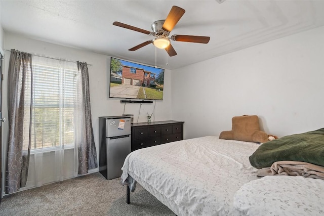 bedroom featuring carpet flooring, ceiling fan, and stainless steel fridge