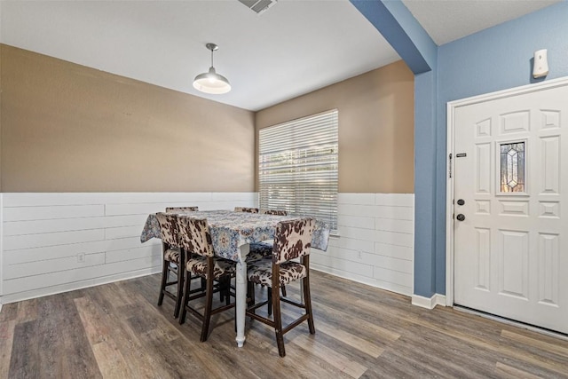 dining area with beamed ceiling and dark hardwood / wood-style flooring