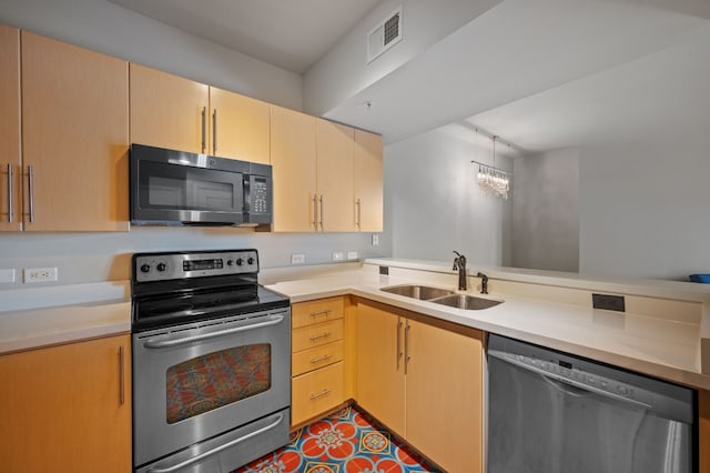 kitchen featuring kitchen peninsula, appliances with stainless steel finishes, light brown cabinetry, sink, and a notable chandelier