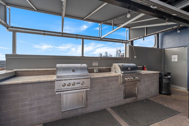 view of patio featuring area for grilling and a grill